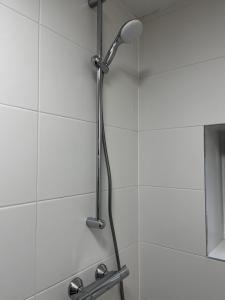 a shower with a shower head in a bathroom at City apartment on the Rhine, Cologne in Cologne