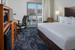 a hotel room with a bed and a desk and a television at Fairfield Inn & Suites Orange Beach in Orange Beach +22 photos