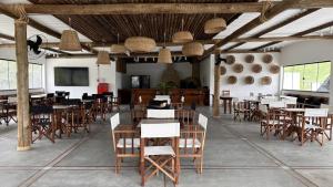 a dining room with wooden tables and chairs at Village Sana Apart Hotel in Sana