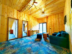 a living room with a couch and chairs in a wooden room at Yabbadabbadoo in Siriu