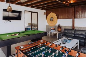 a living room with a pool table and a couch at Villa Lanzarote Deluxe & Spa Pool in Playa Blanca