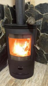a stove with a fire inside of it at Hotel Svanseti in Mestia
