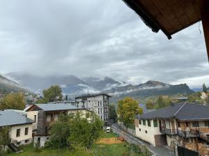 a view of a town with mountains in the background at Hotel Svanseti in Mestia
