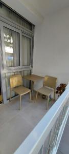 two chairs and a table on a balcony at Apartman Tivat - Centar 1 in Tivat