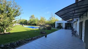 a house with a patio and a yard with a pool at Neferprod Apartments - IS - CAM 05 in Timişoara