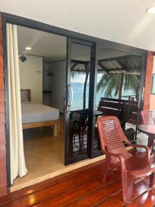 a bedroom with a bed and a piano on a balcony at Pimmada Hut in Haad Pleayleam