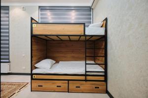 a bedroom with bunk beds in a room at Samarkand Hostel in Samarkand