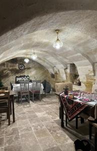 a dining room with tables and chairs in a building at Keyf i ala capadocia in Ürgüp