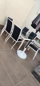 three chairs sitting on the floor in a room at Villa luxueuse in Agadir