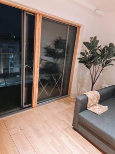 a living room with a couch and a large window at Modern and Spacious 2 bedroom Flat in Streatham in London