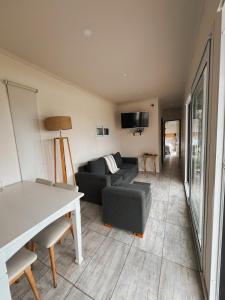 a living room with a couch and a table at Contenedor in Necochea +41 photos