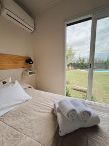 a bedroom with a bed and a large window at Contenedor in Necochea