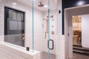 a bathroom with a shower with a glass door at Channel Islands Beach Retreat in Oxnard +45 photos