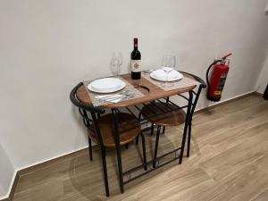 a table with two glasses and a bottle of wine at AL 106 Apartment [Free Wi-fi 5 min dalla Stazione] in Prato