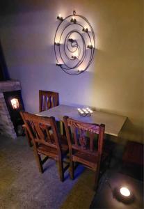 a dining room with a table and chairs and a chandelier at Zakątek u Poety Dąbrówka in Jasło
