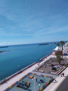 a view of a beach and the ocean at Beautiful room with magic ocean view in Arrecife