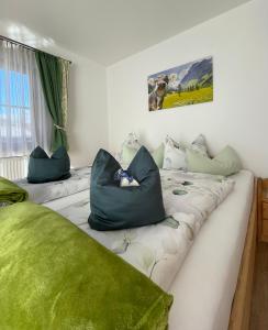 two beds with pillows on them in a room at Haus Hochlenzerblick in Schönau am Königssee