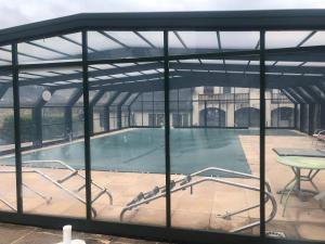 a swimming pool inside of a building at Bel appartement T2 refait à neuf avec piscine couverte de juin à fin septembre, près des stations de ski avec navette et draps et serviettes compris in Bielle