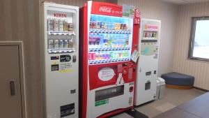 two vending machines in a room with drinks at Hotel Folkloro Ominato in Mutsu