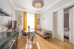 a living room with a table and a couch at Luxury Design 2BR Apartment cozy stay for 5 in Riga