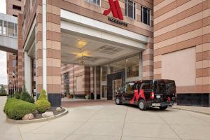 a black vehicle parked in front of a building at Cincinnati Marriott at RiverCenter in Covington