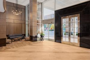 an empty lobby with a large glass door and a couch at Cincinnati Marriott at RiverCenter in Covington