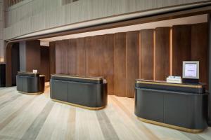 a lobby with a row of counters and wooden walls at Cincinnati Marriott at RiverCenter in Covington