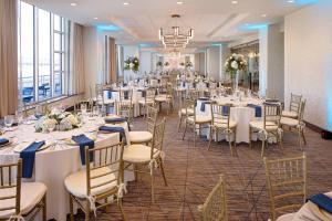 a banquet hall with white tables and chairs at Cincinnati Marriott at RiverCenter in Covington