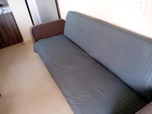a blue couch sitting in a room with at Casa Marsella in Playa Bello Horizonte