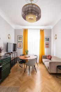 a living room with a couch and a table at Luxury Design Apartment Riga in Rīga