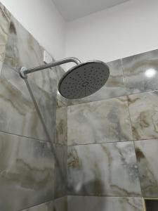 a shower with a shower head in a bathroom at Sharz place - Mombasa in Mombasa