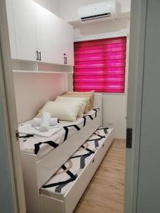 Letto a castello in camera con finestra rosa di Léo's Cachette a Naga