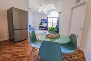 a dining room with a table and four chairs at New APT 15Min Drive Disney and Airport - Parks KingBed Pets in Kissimmee