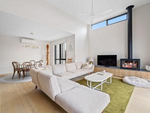 a living room with a couch and a fireplace at Wirilda Retreat in Inverloch