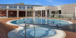 a large swimming pool in front of a building at Wirilda Retreat in Inverloch