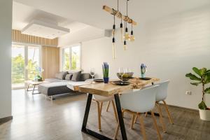 a living room with a table and chairs and a couch at Eclipse Vouliagmeni Center in Athens