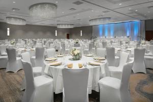 a banquet hall with white tables and chairs at West Des Moines Marriott in West Des Moines +34 photos