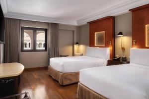 A bed or beds in a room at JW Marriott El Convento Cusco