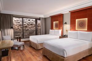 A bed or beds in a room at JW Marriott El Convento Cusco