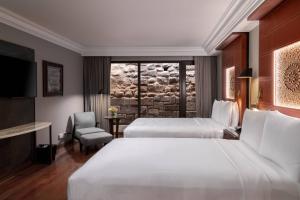 A bed or beds in a room at JW Marriott El Convento Cusco