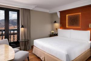 A bed or beds in a room at JW Marriott El Convento Cusco