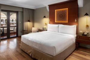 A bed or beds in a room at JW Marriott El Convento Cusco
