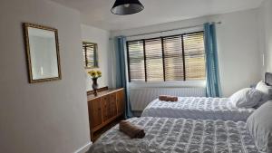 a bedroom with two beds and a mirror and a window at Amani Bungalow in Brandon
