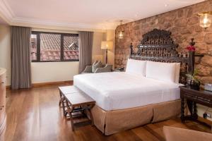 A bed or beds in a room at JW Marriott El Convento Cusco