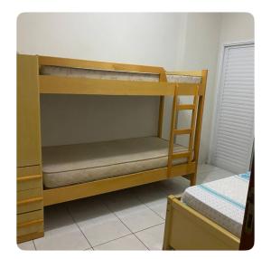 a set of bunk beds in a room at Apartamento aconchegante in Praia Grande