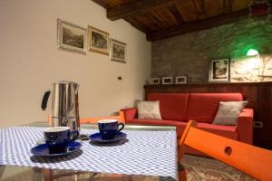 a table with a coffee maker and two cups on it at Piccolo Rifugio - Alpine Studio flat Valtournenche in Valtournenche