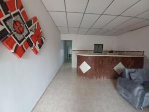 a waiting room with a couch and a tv on a wall at Apartamento Jarhel in Aguachica