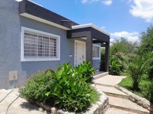 a house with a pathway leading to the front door at Nuevo Amanecer in Villa Los Aromos