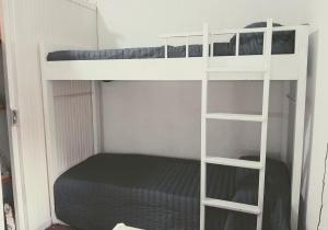 a bedroom with two bunk beds and a bed at Monoambiente céntrico in Mar de Ajó