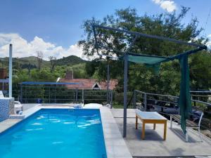a pool with a table and a bench next to it at Nuevo Amanecer in Villa Los Aromos